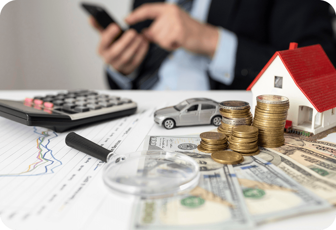 Coins and a model house representing financial services